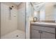 Bright bathroom showing walk-in shower, vanity with mirror, and updated fixtures at 7911 Floradora Dr, New Port Richey, FL 34654