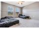 Bedroom featuring two windows and neutral carpeting at 7911 Floradora Dr, New Port Richey, FL 34654