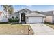 Charming single-story home with well-maintained lawn and attached two-car garage at 7911 Floradora Dr, New Port Richey, FL 34654
