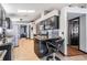 Open kitchen featuring stainless steel appliances, granite countertops, dark cabinets, tile backsplash and skylights at 7911 Floradora Dr, New Port Richey, FL 34654