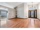 Bright living room featuring wood flooring and access to the front door at 7911 Floradora Dr, New Port Richey, FL 34654