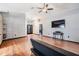 Bright living room featuring wood flooring, fan, and access to the front door at 7911 Floradora Dr, New Port Richey, FL 34654