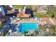 Aerial view of the pool, featuring clear blue water, lounge chairs and umbrellas at 8024 Feather Ct # D, Hudson, FL 34667