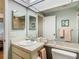 Bathroom featuring a single sink vanity with updated fixtures and a framed mirror at 8024 Feather Ct # D, Hudson, FL 34667