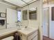 Bathroom featuring a single sink vanity and a framed mirror at 8024 Feather Ct # D, Hudson, FL 34667