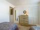 Bedroom view showcasing a chest of drawers, closet, and two twin beds at 8024 Feather Ct # D, Hudson, FL 34667
