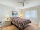 Bedroom featuring a comfortable bed, ceiling fan, and natural light from a window at 8024 Feather Ct # D, Hudson, FL 34667