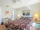 Spacious bedroom with a floral-patterned bedspread, desk, and en-suite bathroom at 8024 Feather Ct # D, Hudson, FL 34667