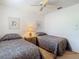 Bright bedroom featuring twin beds, ceiling fan, and natural light at 8024 Feather Ct # D, Hudson, FL 34667