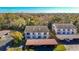 Aerial view of community buildings with covered parking surrounded by mature trees and landscaping at 8024 Feather Ct # D, Hudson, FL 34667