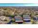 Aerial view of community buildings with covered parking surrounded by mature trees and landscaping at 8024 Feather Ct # D, Hudson, FL 34667