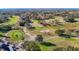 Expansive aerial view of a scenic golf course with mature trees and manicured greens at 8024 Feather Ct # D, Hudson, FL 34667