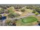Picturesque aerial view of a lush green golf course with golfers and ponds at 8024 Feather Ct # D, Hudson, FL 34667