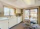 Eat-in kitchen with white cabinets, table and chairs offering a cozy dining space at 8024 Feather Ct # D, Hudson, FL 34667