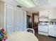 Kitchen featuring white cabinets, stainless steel refrigerator, stove, with an adjacent dining area at 8024 Feather Ct # D, Hudson, FL 34667