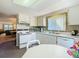 Bright kitchen featuring white cabinetry, countertops, appliances, and a breakfast nook under a window at 8024 Feather Ct # D, Hudson, FL 34667