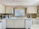 Bright kitchen with white cabinets, sink, dishwasher and countertops, offering a clean, functional space at 8024 Feather Ct # D, Hudson, FL 34667