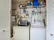 Well-organized laundry area with a washer, dryer, and storage shelving at 8024 Feather Ct # D, Hudson, FL 34667
