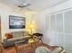 Bright living room featuring a comfortable sofa, glass coffee table, and white closet doors at 8024 Feather Ct # D, Hudson, FL 34667