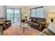 Cozy living room with a glass coffee table and sliding door access to the balcony at 8024 Feather Ct # D, Hudson, FL 34667