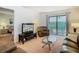 Bright living room featuring a sitting area and a sliding door access to the balcony at 8024 Feather Ct # D, Hudson, FL 34667
