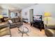 Cozy living room featuring a brown leather sofa, a TV, and a glass coffee table at 8024 Feather Ct # D, Hudson, FL 34667