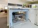 Oven and interior view showing muffin tins and various cookware at 8024 Feather Ct # D, Hudson, FL 34667
