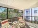 Relax on the screened porch, furnished with comfortable seating for enjoying fresh air at 8024 Feather Ct # D, Hudson, FL 34667