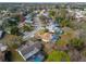 Residential neighborhood aerial showcasing various homes, green spaces, and winding streets at 8701 Braxton Dr, Hudson, FL 34667