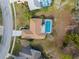 Aerial view showcasing the property's layout, including the home, pool, and surrounding landscaping at 8701 Braxton Dr, Hudson, FL 34667
