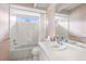 Cozy bathroom featuring floral wallpaper, a tub-shower combo, and a single sink vanity at 8701 Braxton Dr, Hudson, FL 34667
