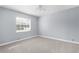 Empty bedroom featuring neutral walls, carpet, ceiling fan and a window with blinds, flooded with light at 8701 Braxton Dr, Hudson, FL 34667