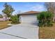 Charming single-story home with a well-maintained lawn and a two-car garage at 8701 Braxton Dr, Hudson, FL 34667