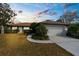 Charming single-story home with a well-manicured lawn and a two-car garage at 8701 Braxton Dr, Hudson, FL 34667