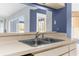 Kitchen sink featuring stainless steel faucet and a view to the dining area at 8701 Braxton Dr, Hudson, FL 34667
