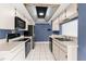 Well-lit kitchen with white cabinets, black appliances, and tile backsplash at 8701 Braxton Dr, Hudson, FL 34667