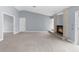 Bright living room featuring neutral paint, a fireplace, and a sliding door to the back at 8701 Braxton Dr, Hudson, FL 34667