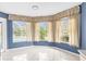 Bright living area featuring large windows, pool view, tile floors and stylish curtains at 8701 Braxton Dr, Hudson, FL 34667