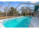 Inviting screened-in pool with crystal clear water, perfect for relaxation and recreation at 8701 Braxton Dr, Hudson, FL 34667