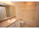 Clean bathroom featuring a vanity, toilet, and tiled shower-tub combination at 9404 Crescent Loop Cir # 104, Tampa, FL 33619