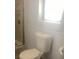 Clean bathroom features toilet, shower, and a window for natural light at 9620 Pieces Of Eight Trl, Placida, FL 33946