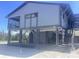 Exterior view of a stilted beach house with stairs and a covered area at 9620 Pieces Of Eight Trl, Placida, FL 33946