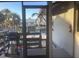 View from a screened porch showcases grill and glimpses of the landscaping and nearby buildings at 9620 Pieces Of Eight Trl, Placida, FL 33946