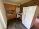 Kitchen with wood cabinets, white appliances, and unique backsplash design at 9707 Lithia Pinecrest Rd, Lithia, FL 33547