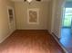 Living room with wood-look floors and glass door offering natural light at 9707 Lithia Pinecrest Rd, Lithia, FL 33547