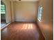 Living room with wood-look floors and a large window offering natural light at 9707 Lithia Pinecrest Rd, Lithia, FL 33547
