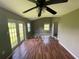 Sunroom with wood-look floors, a ceiling fan, and lots of natural light at 9707 Lithia Pinecrest Rd, Lithia, FL 33547