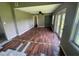 Sunroom with wood-look floors, a ceiling fan, and glass doors at 9707 Lithia Pinecrest Rd, Lithia, FL 33547