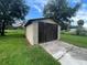 Wooden shed with driveway and green lawn at 9707 Lithia Pinecrest Rd, Lithia, FL 33547