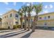 Bright, two-story condo building with palm trees and ample parking at 9895 1St E St # 5, Treasure Island, FL 33706